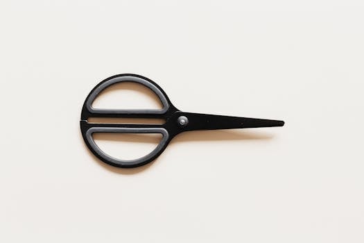 Sleek black scissors on a beige background captured in a minimalist style.