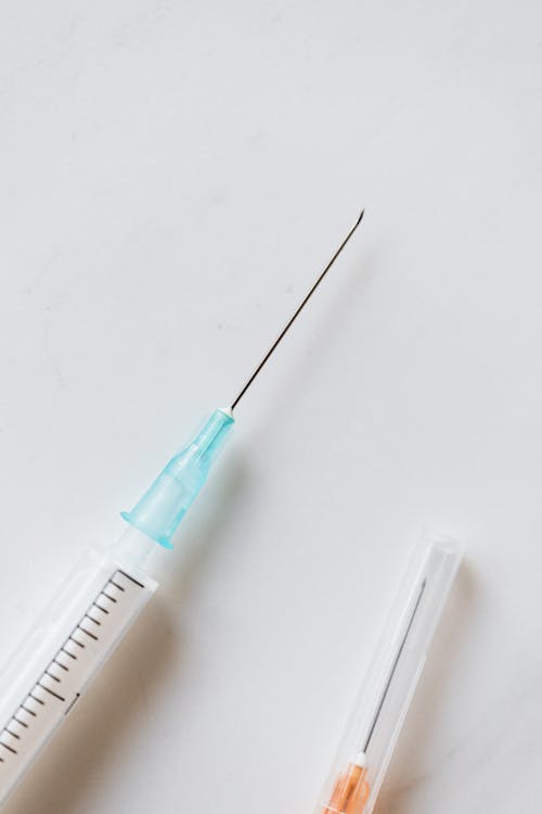 Syringes placed on white surface