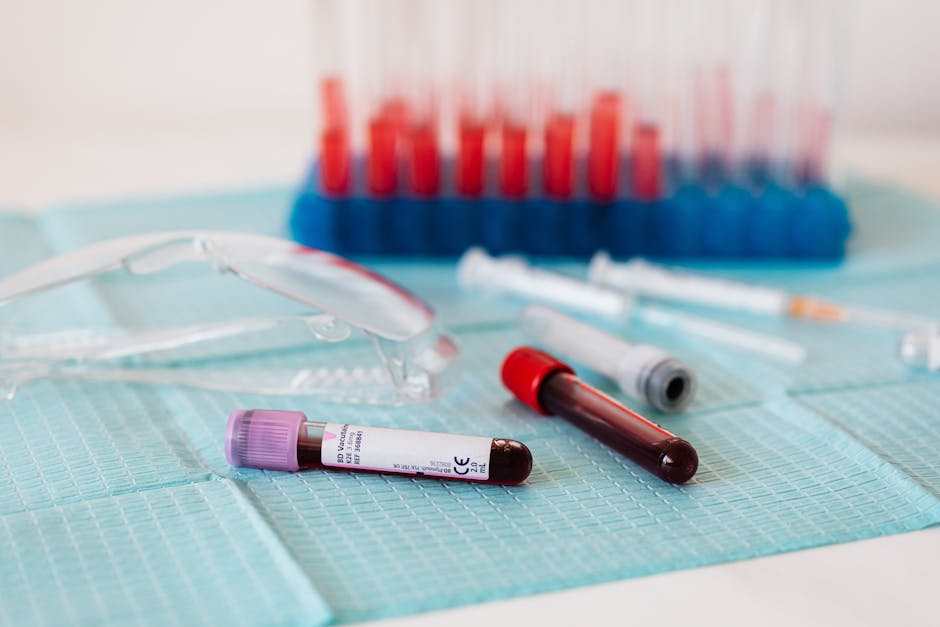 Full vials of blood near various medical equipment for taking blood