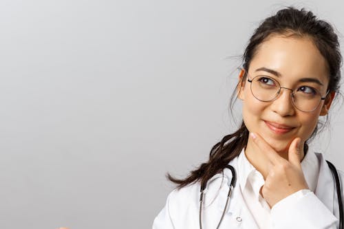 Woman Wearing a Lab Coat and Eyeglasses