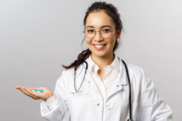 A Doctor Holding Blue Pills