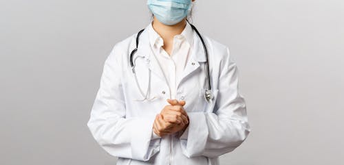 Free Close-Up Shot of a Doctor Wearing a Lab Coat and Stethoscope  Stock Photo