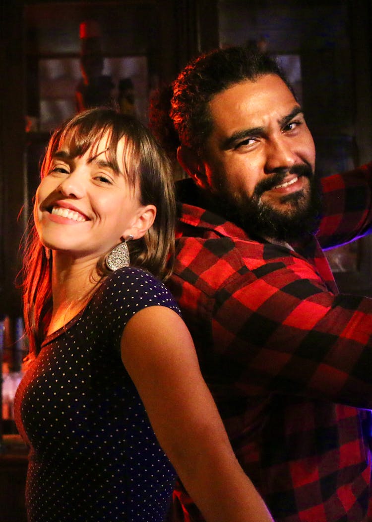 Happy Young Diverse Couple Standing Back To Back And Looking At Camera