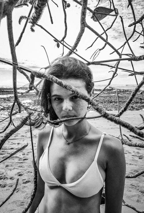 Serene fit young woman recreating on sandy beach in tropical resort