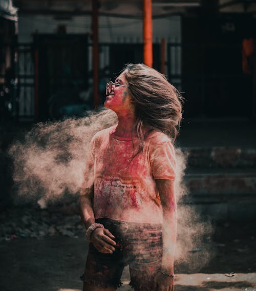 Close-Up Shot of a Woman Covered in Holi Powder