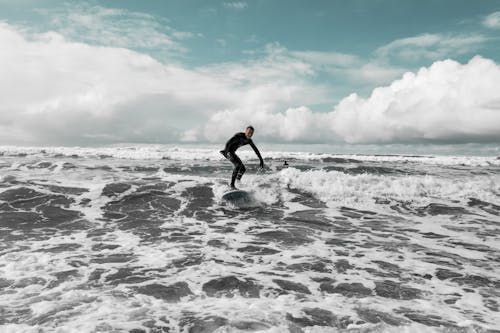 Free Man in Black Wetsuit Surfing the Waves Stock Photo