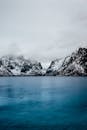 Snow Covered Mountain Beside Body of Water