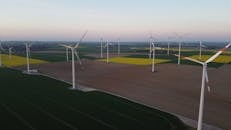 White Wind Turbines on Green Grass Field