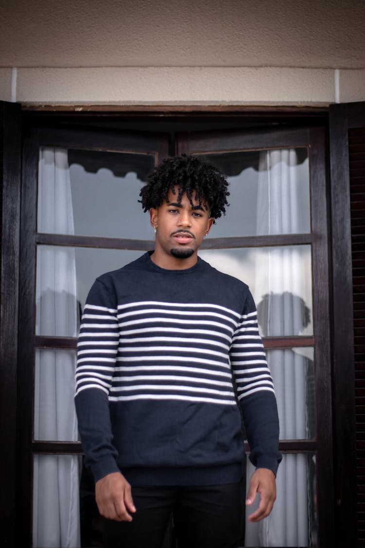 Stylish African American Man In Striped Clothes Near Glass Door