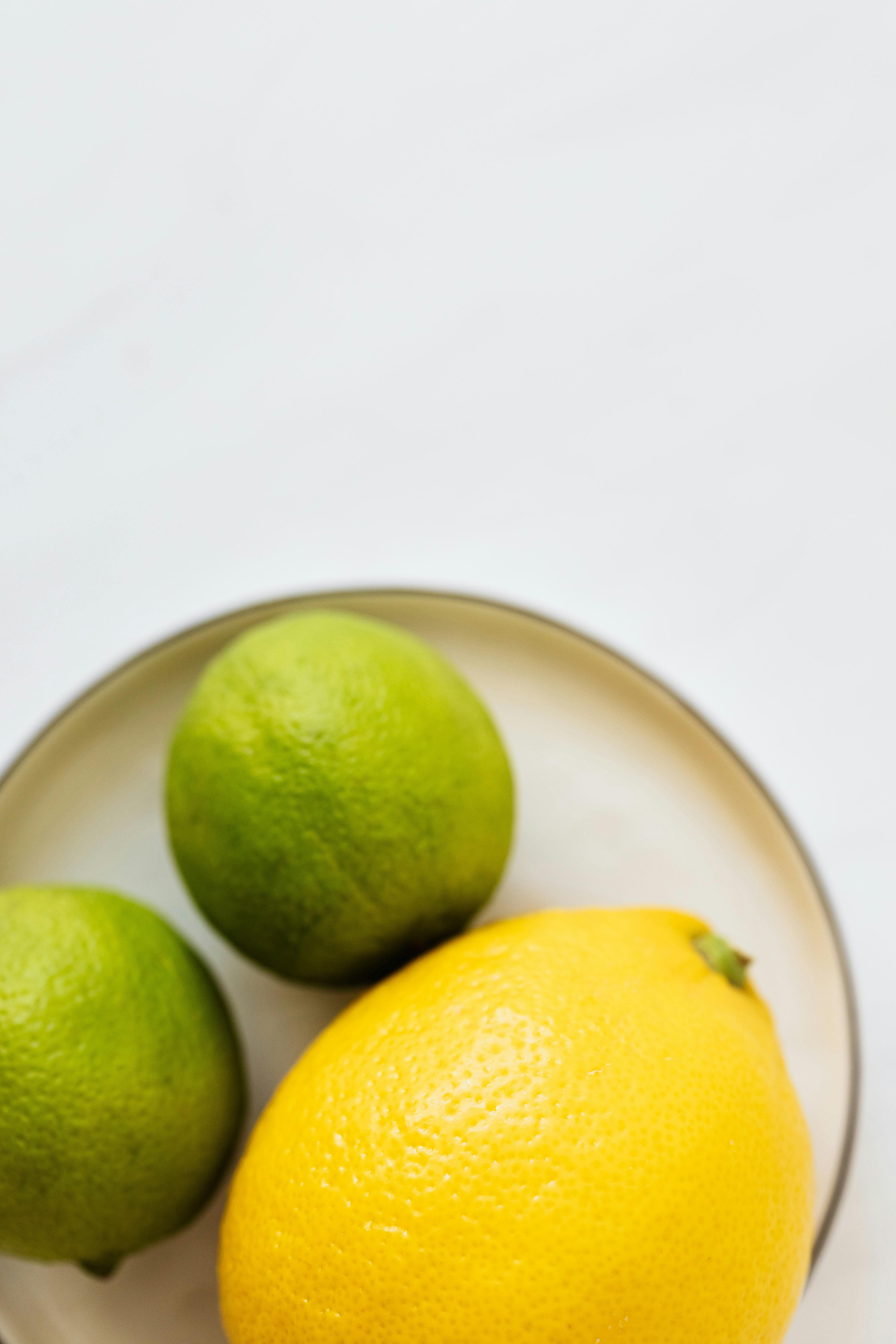 lemon and limes on metal plate