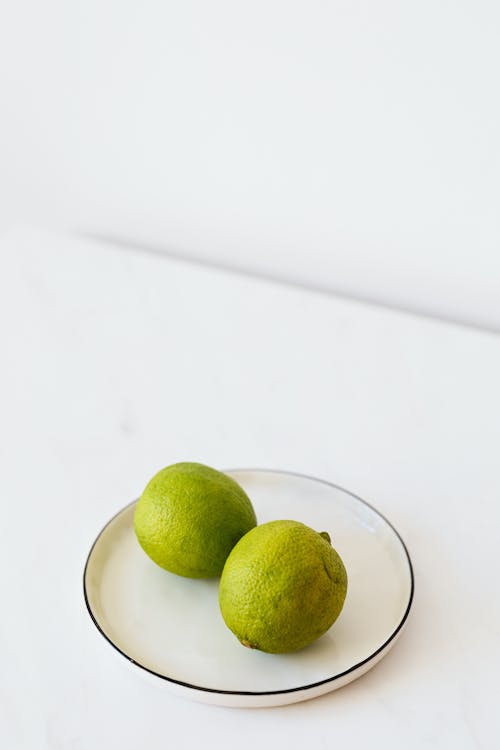 Free Ripe limes served on plate Stock Photo