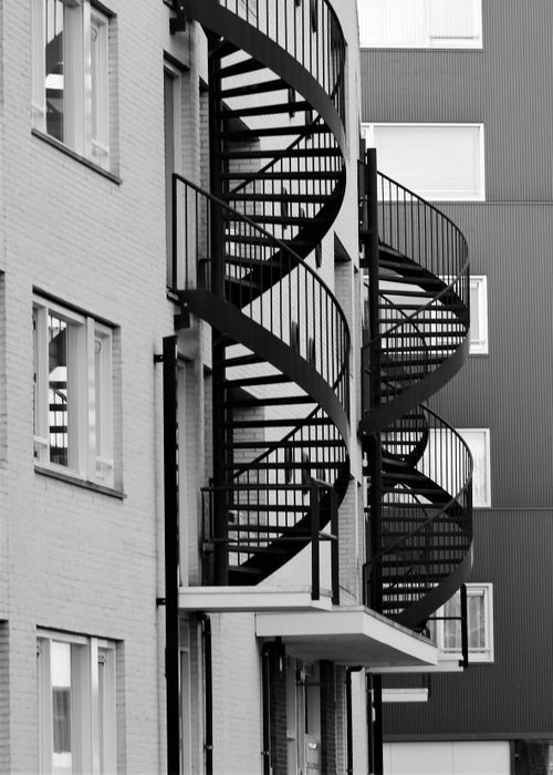 Free Black and white photo of modern buildings in the Netherlands featuring spiral staircases. Stock Photo