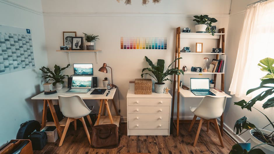 Erie vs Nationwide: Midwest Storm Claims Showdown A well-organized home office featuring dual desks, laptops, indoor plants, and natural light.