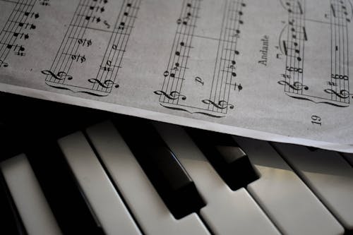 Close-Up Shot of Musical Notes and Piano Keys