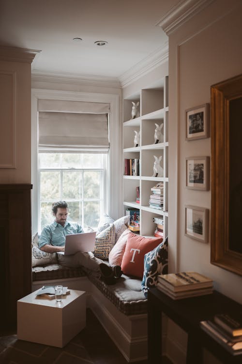 Free Man Using a Laptop at Home Stock Photo
