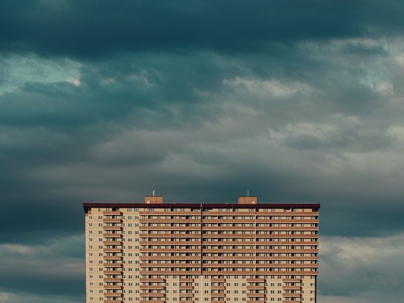 Residential apartment building against a dramatic sky
