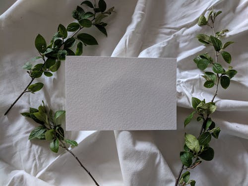 Close-Up Shot of a Blank Card on White Textile