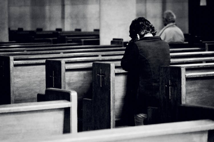 Unrecognizable Men Praying In Old Catholic Church