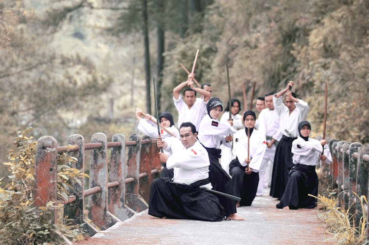 People Holding Katana Swords