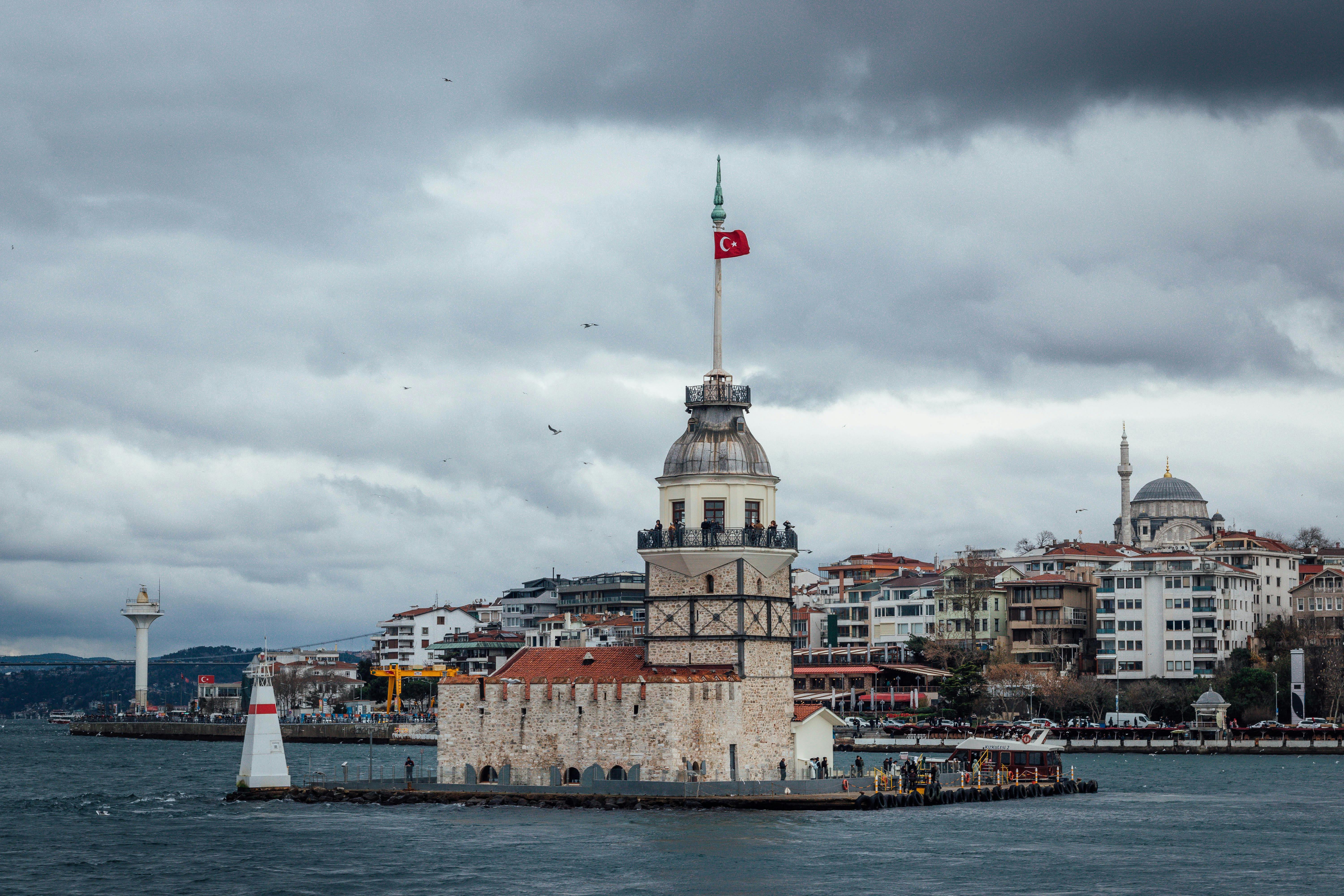 Aged buildings of city on sea water · Free Stock Photo