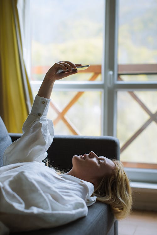 Free Woman in White Long Sleeve Shirt Taking a Selfie Stock Photo