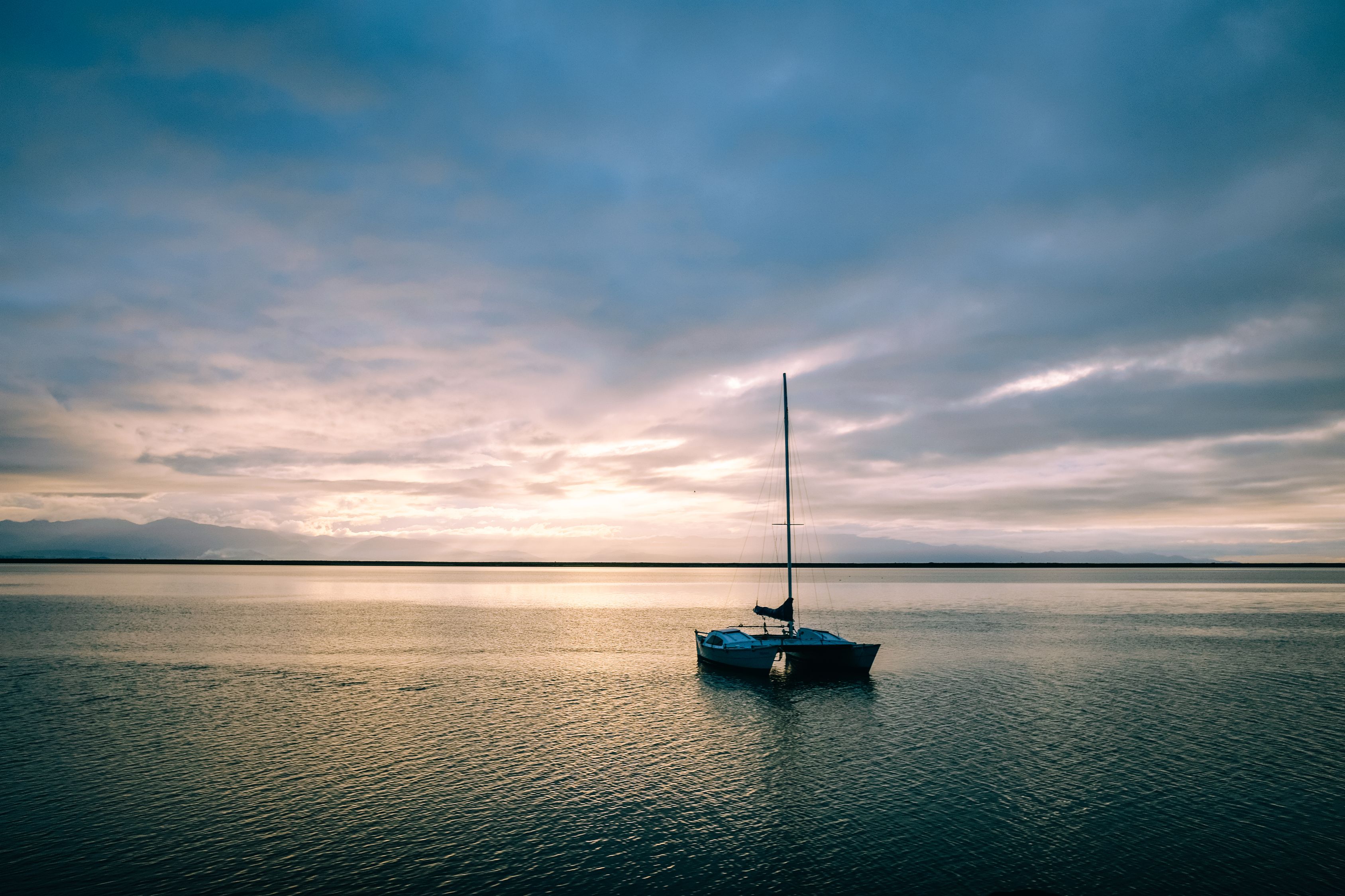 Floating Calm Boat floating in calm sea in evening time · Free Stock Photo
