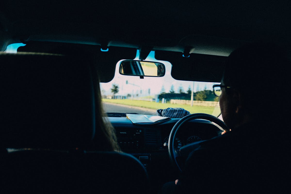 Driving instructor and learner in a right-hand-drive car during a lesson.