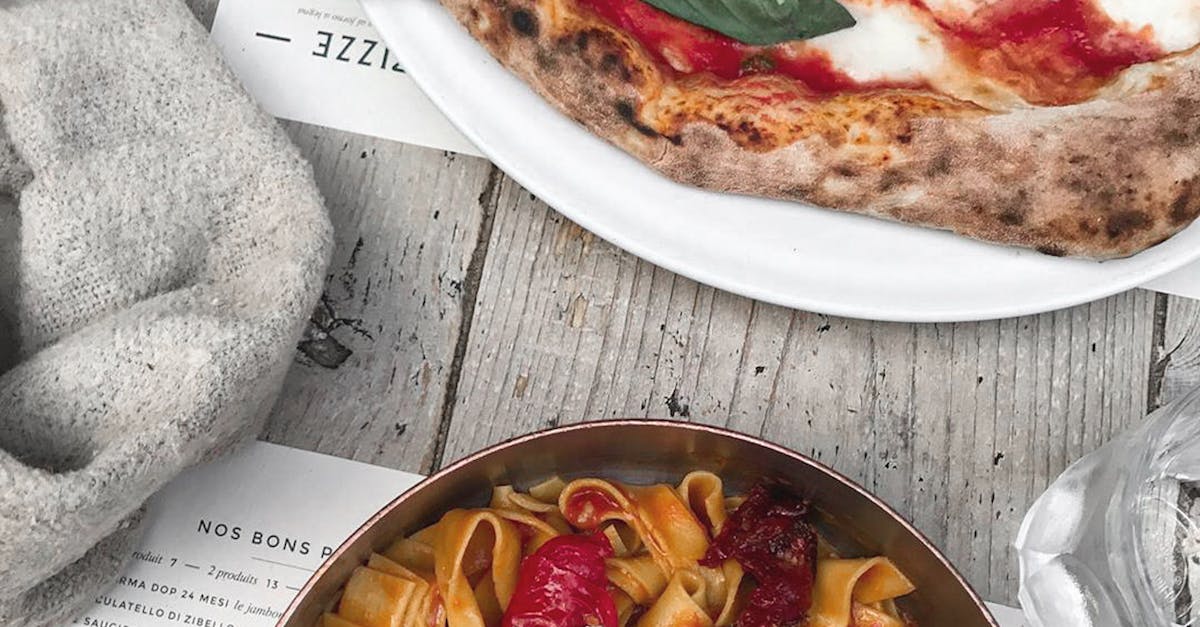 Delicious Italian pizza and pasta on restaurant table