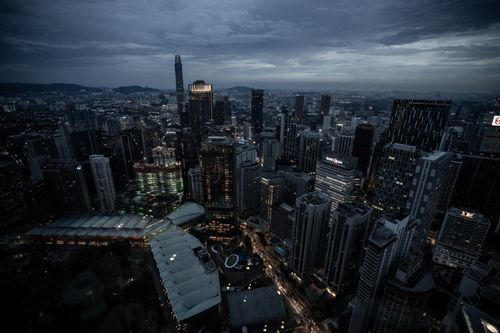 Free Aerial view of Kuala Lumpur's skyline, showcasing illuminated skyscrapers and urban landscape at night. Stock Photo