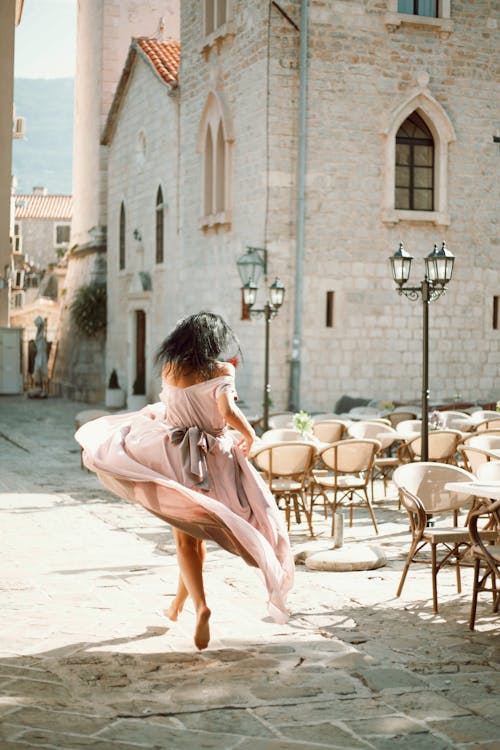 Woman in Pink Dress Running on Bare Feet