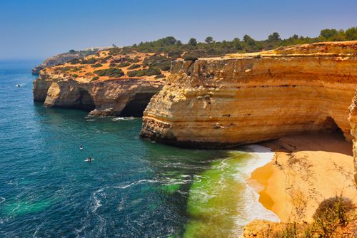 Free A breathtaking aerial view of Algarve cliffs and turquoise waters in Portugal's Praia de Corredoura. Stock Photo