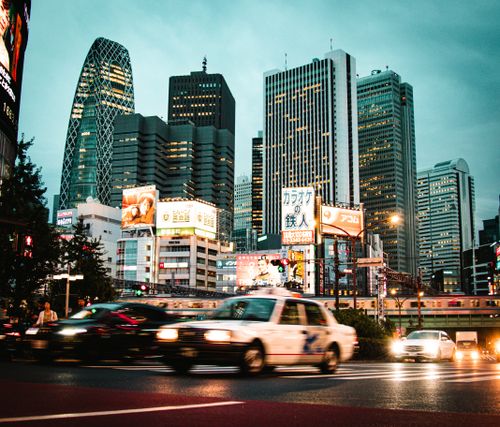 Free Vibrant cityscape of Shinjuku, Tokyo with skyscrapers and bustling traffic at night. Stock Photo