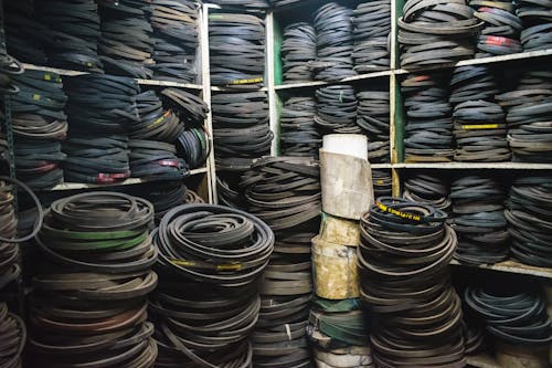Free Lots of Rubber Belts on Shelves and Floor Stock Photo