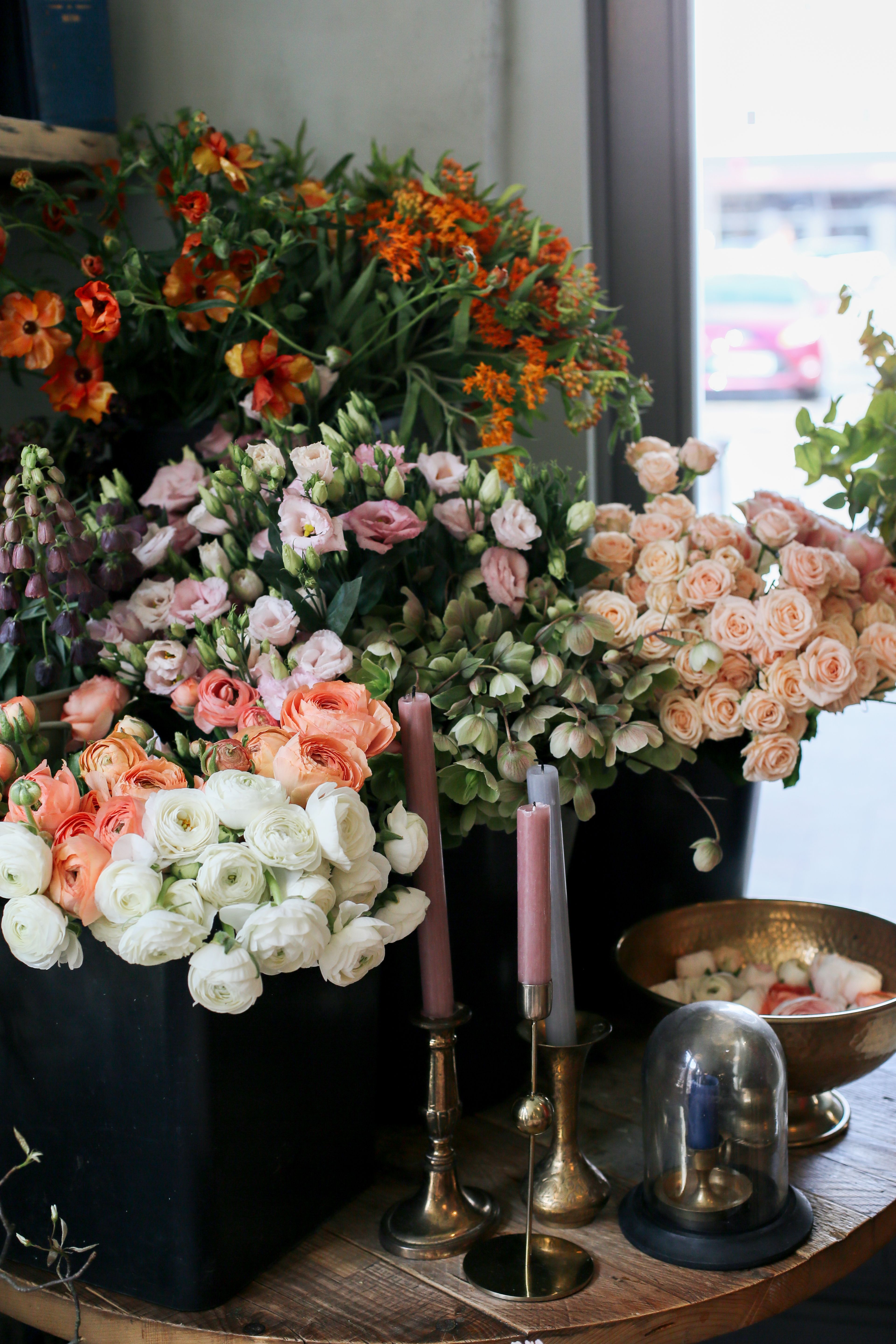 Beautiful display of fresh flowers with candlesticks on a table indoors.