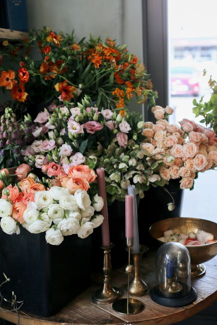 Beautiful display of fresh flowers with candlesticks on a table indoors.
