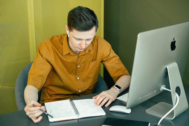 Man Looking At His Sketchbook