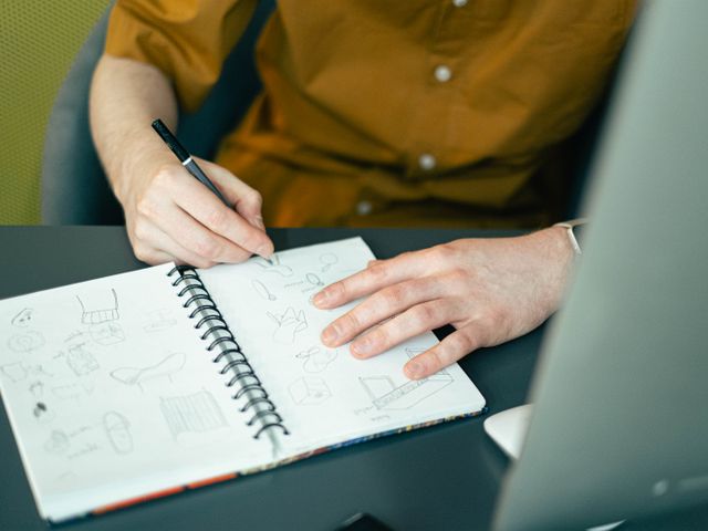 Notebook with handwritten audience personas beside a coffee cup