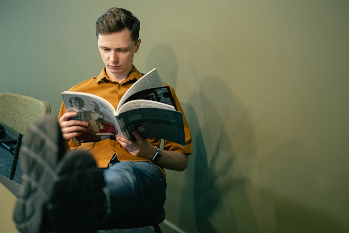 Free Man Reading a Book Stock Photo