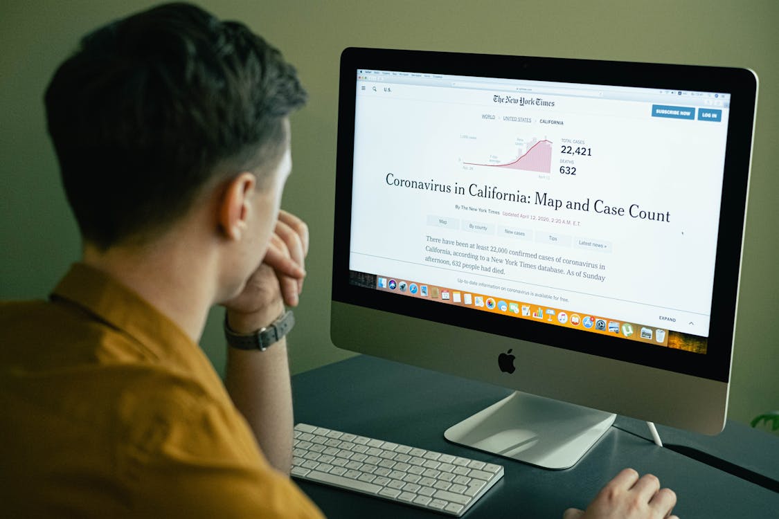 Person Reading News on his Computer · Free Stock Photo