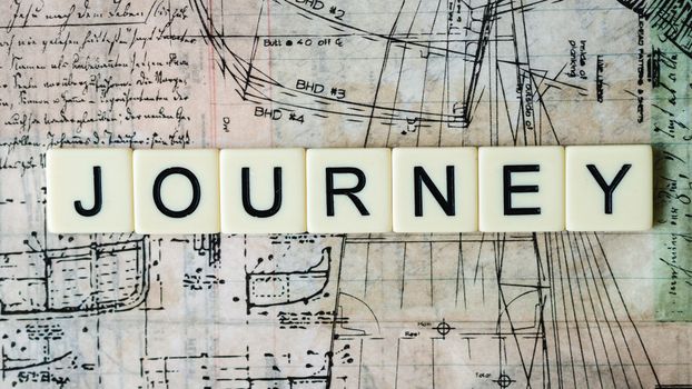 Vintage map background with scrabble tiles spelling 'Journey'. Ideal for travel and adventure themes.