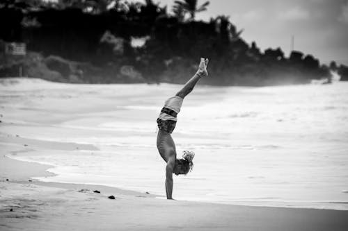 Monochrome Photo of a Man Doing a Handstand