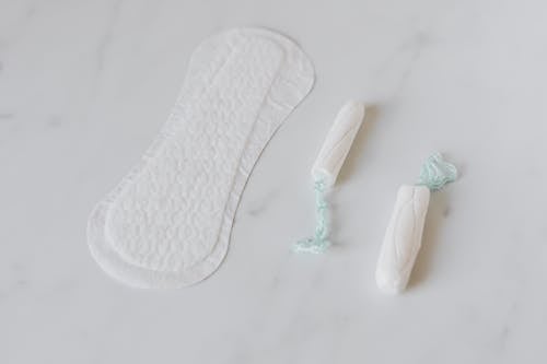 Free Tampons and daily liner on white surface Stock Photo