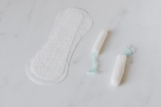 Tampons and daily liner on white surface