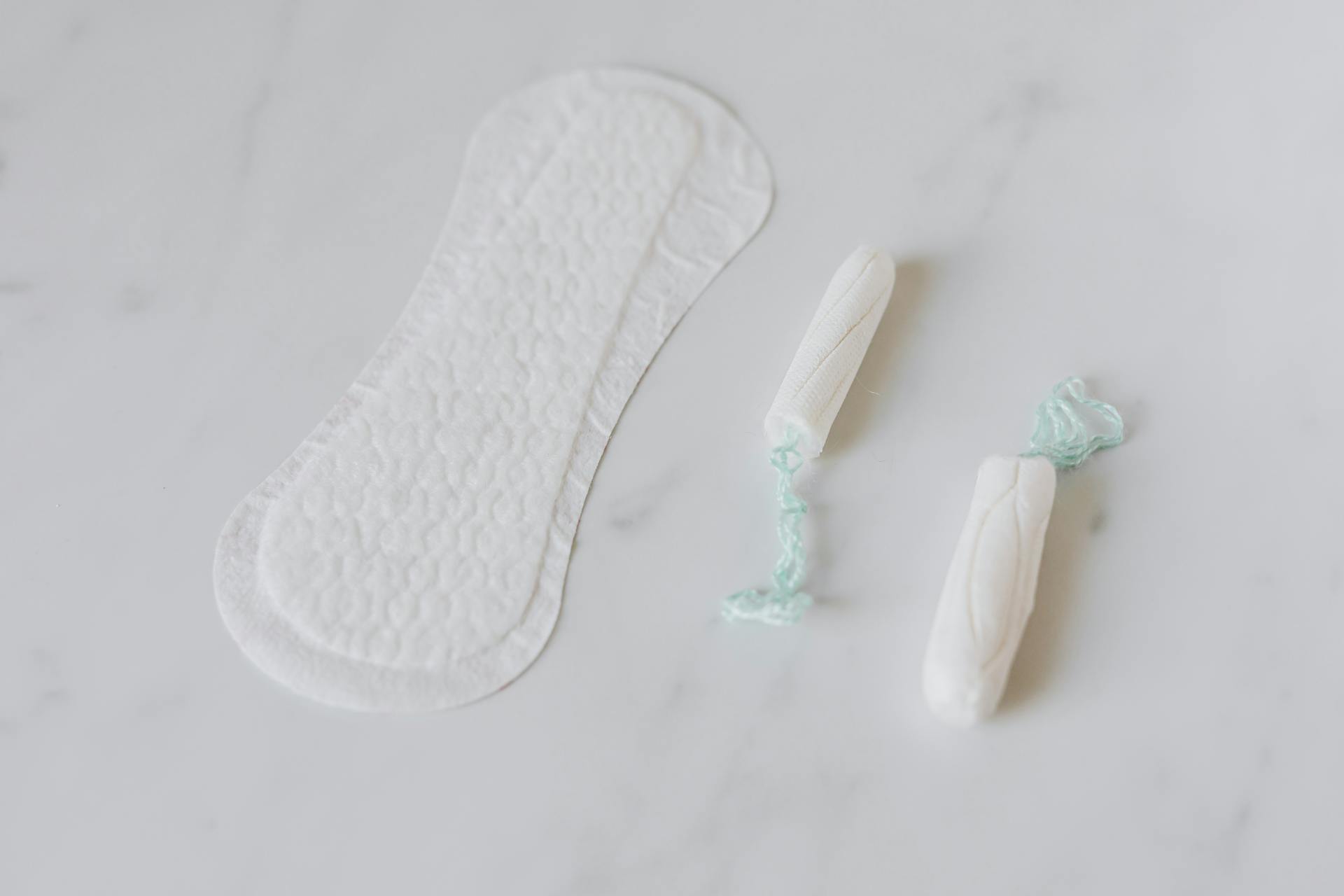 Tampons and daily liner on white surface
