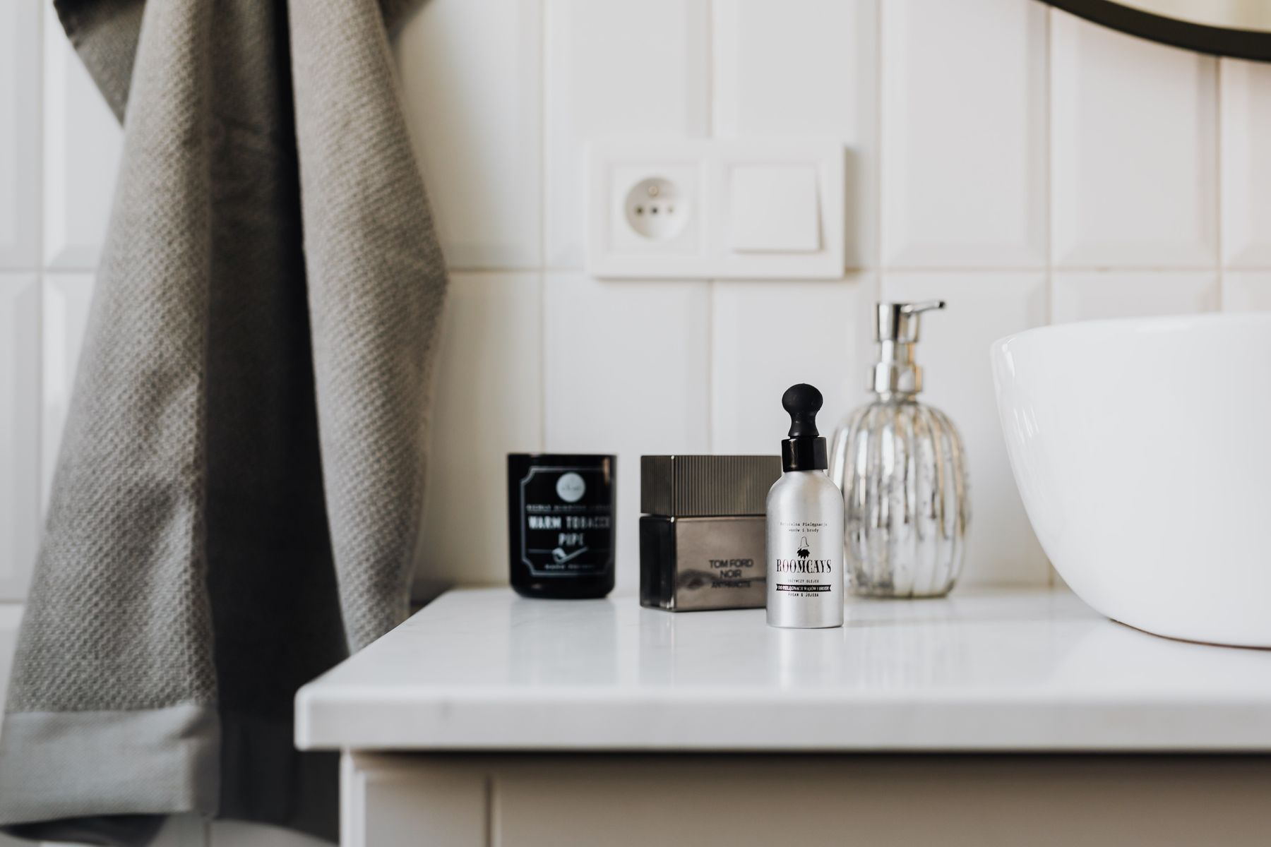 Personal care products arranged neatly beside a bathroom sink for an everyday skincare routine