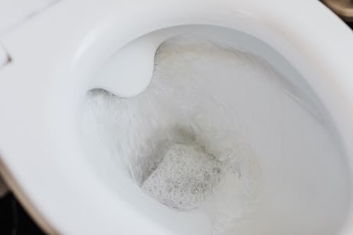 Free Flushing water in white toilet bowl Stock Photo