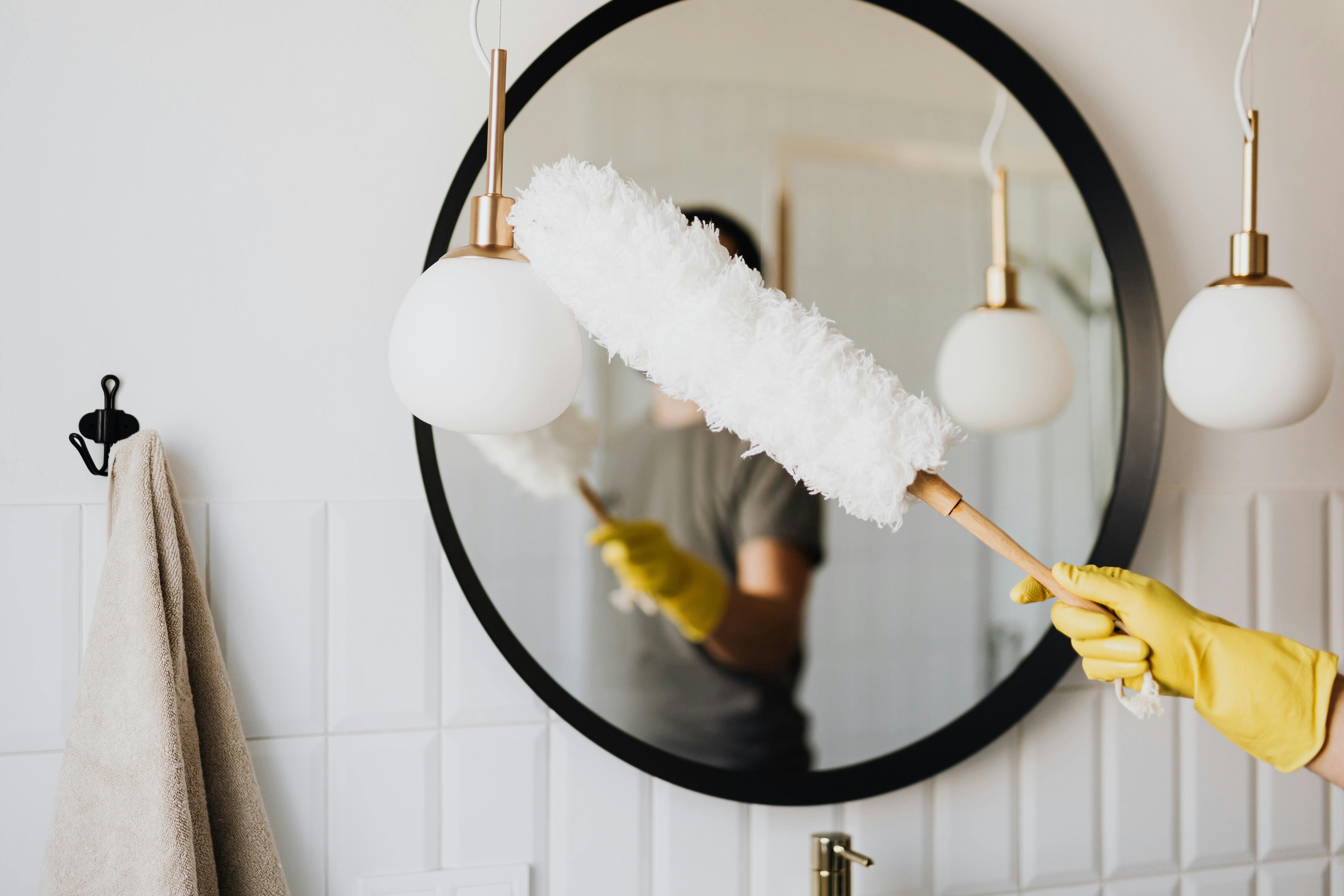 Free Crop woman dusting lamp during housework Stock Photo