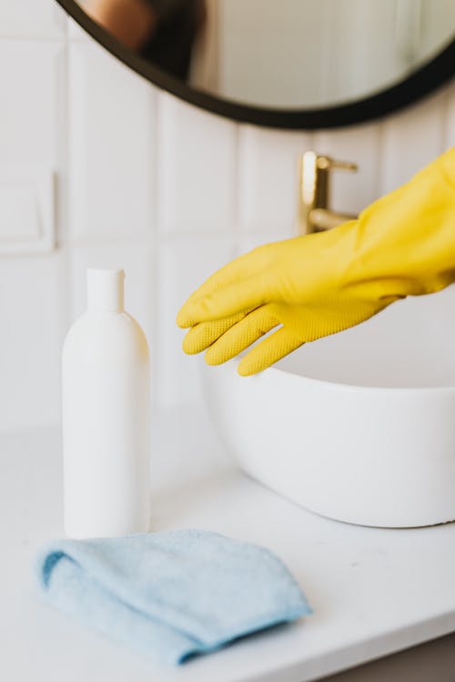Free Crop person in cleaning glove in bathroom Stock Photo