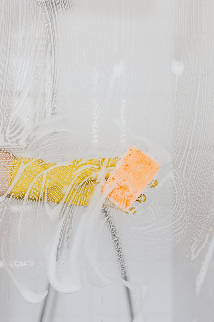 Person In Glove Washing Glass Partition In Modern Bathroom