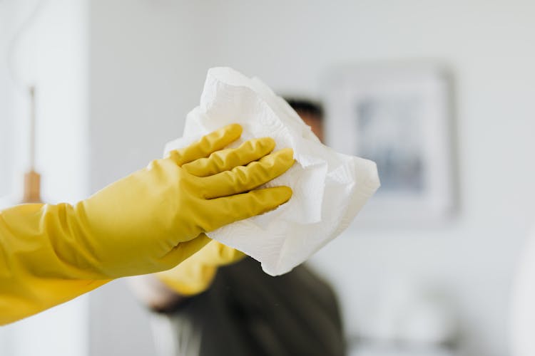 Unrecognizable Man Cleaning Mirror In Modern Bathroom